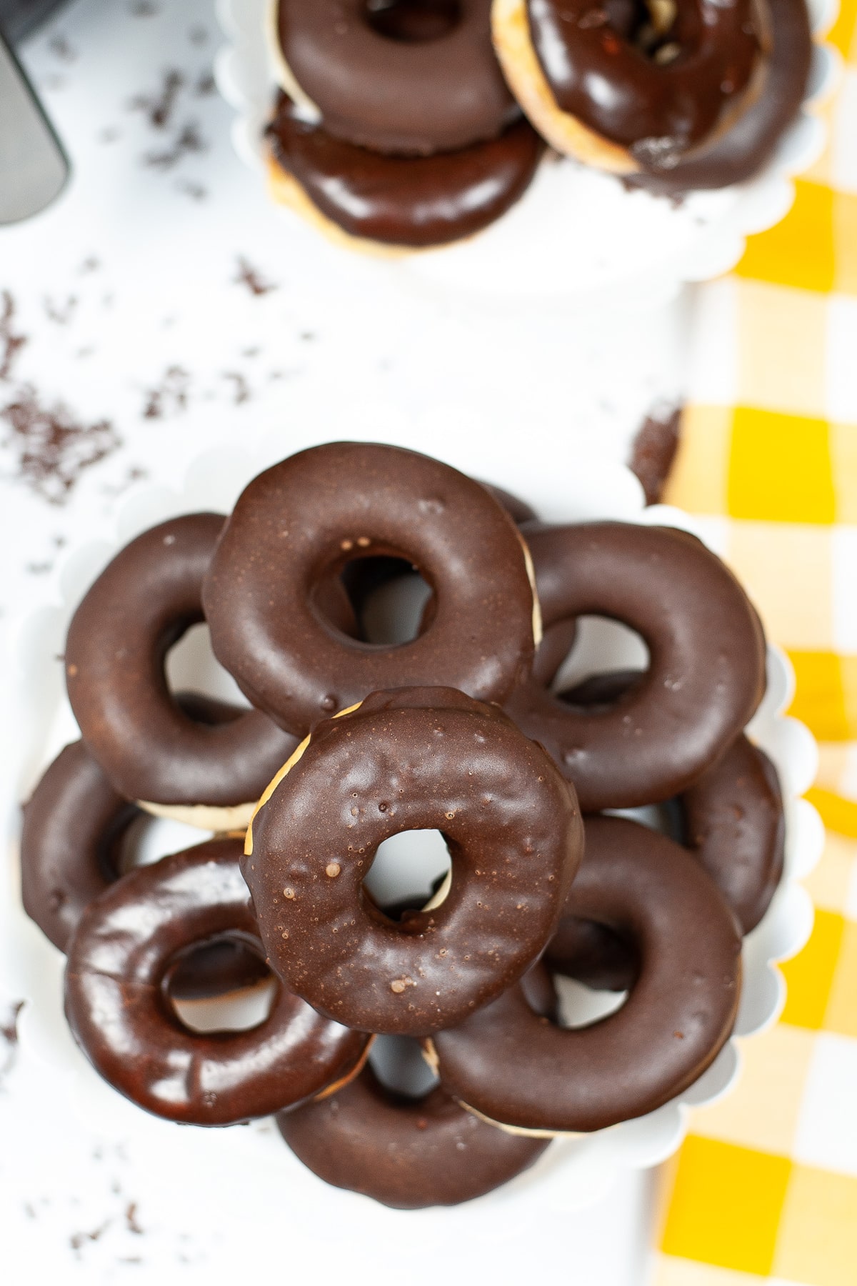 A top view of Chocolate Glazed Air Fryer Donuts on a white counter.
