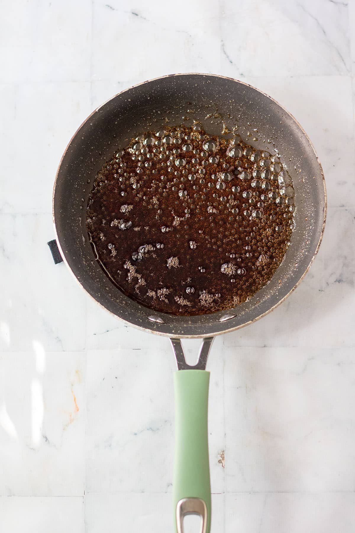 Boiling Coca-cola liquid in a pan