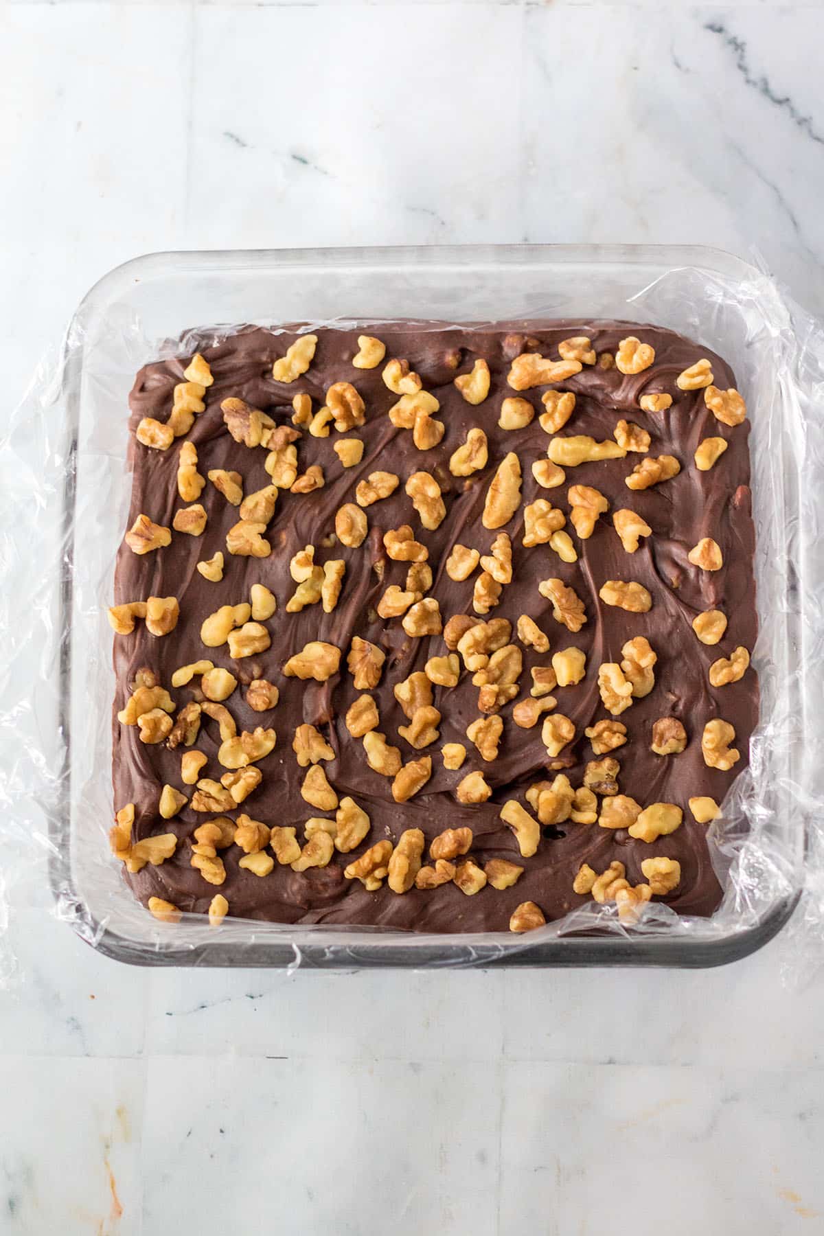 Coca-cola fudge in square pan with generous walnuts on top