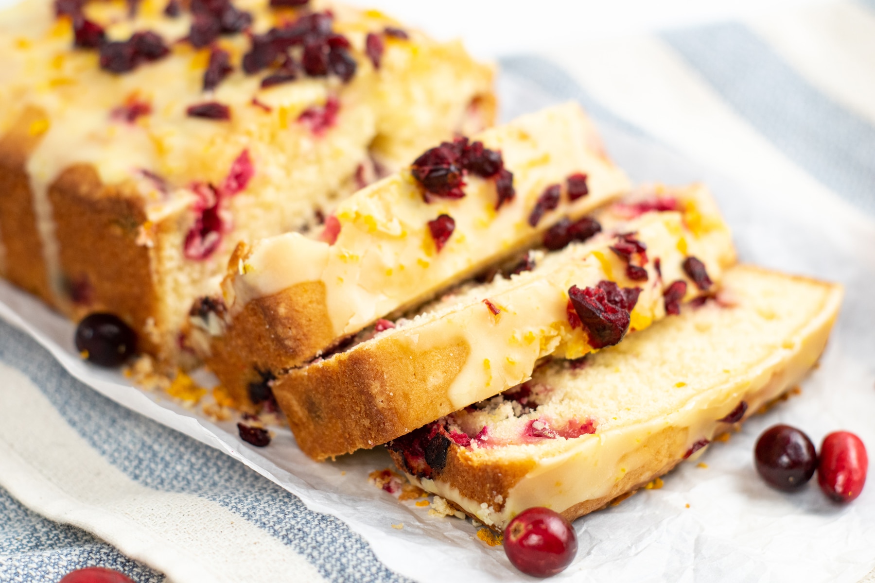 Loaves of Cranberry Orange Pound Cake with striped linen