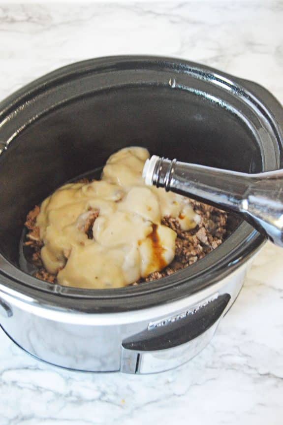 Pouring of Worcestershire sauce to the crockpot with other ingredients