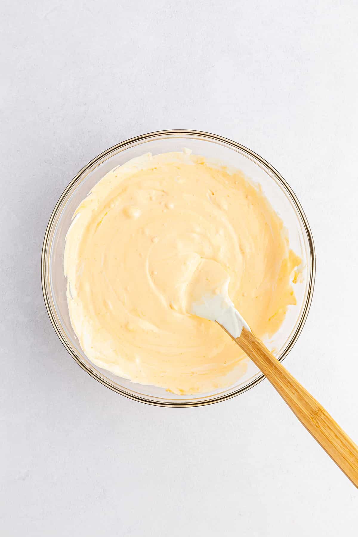 Creamy pudding mixture in light orange hue
