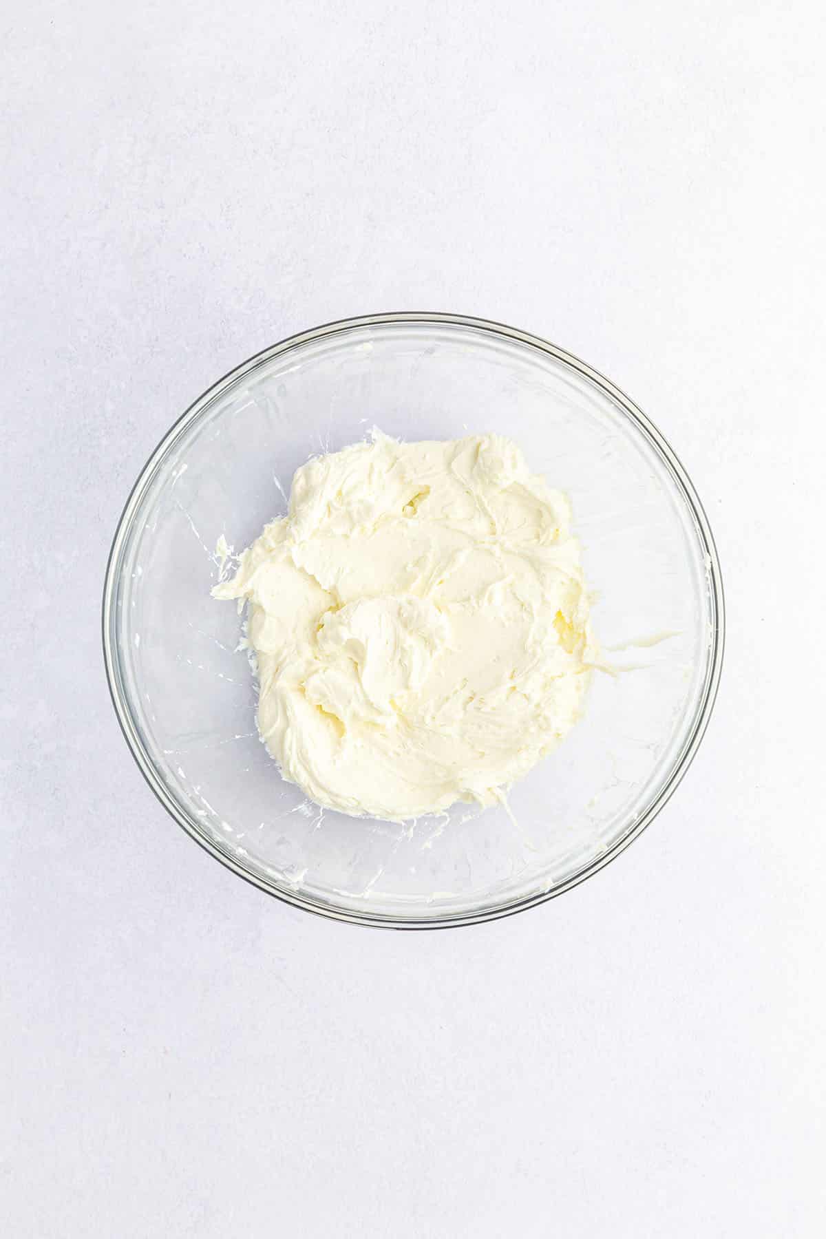 Softly whipped cream cheese in a glass bowl