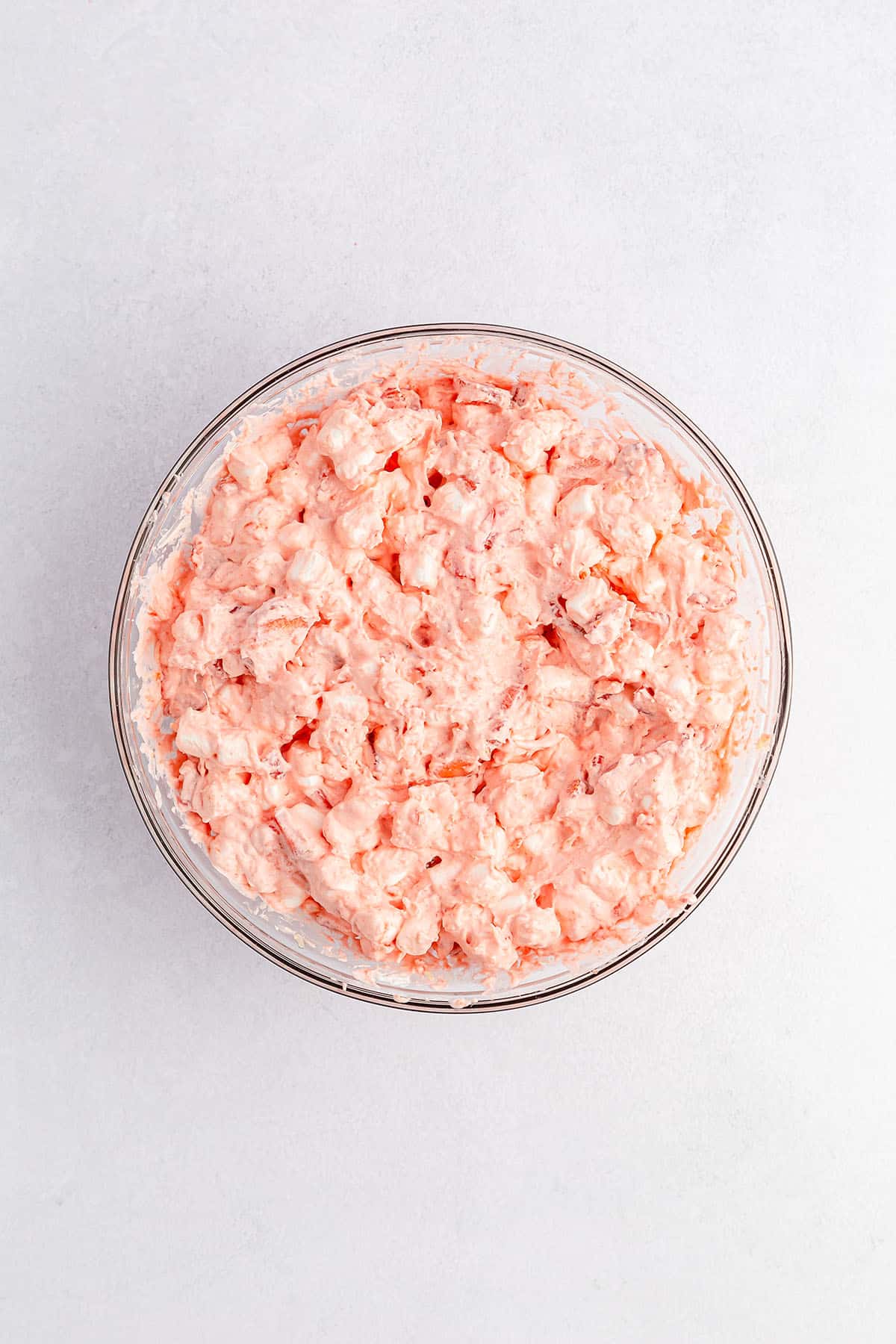 Combined ingredients of strawberry fluff salad in a mixing bowl