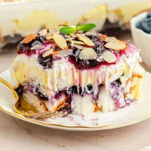 blueberry layer cake on white plate with a bite out