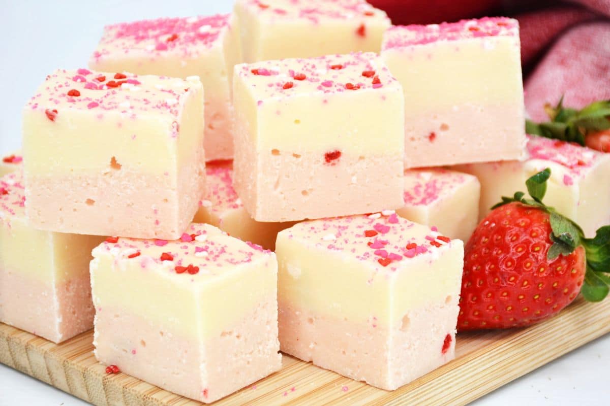 pink and white fudge squares on cutting board