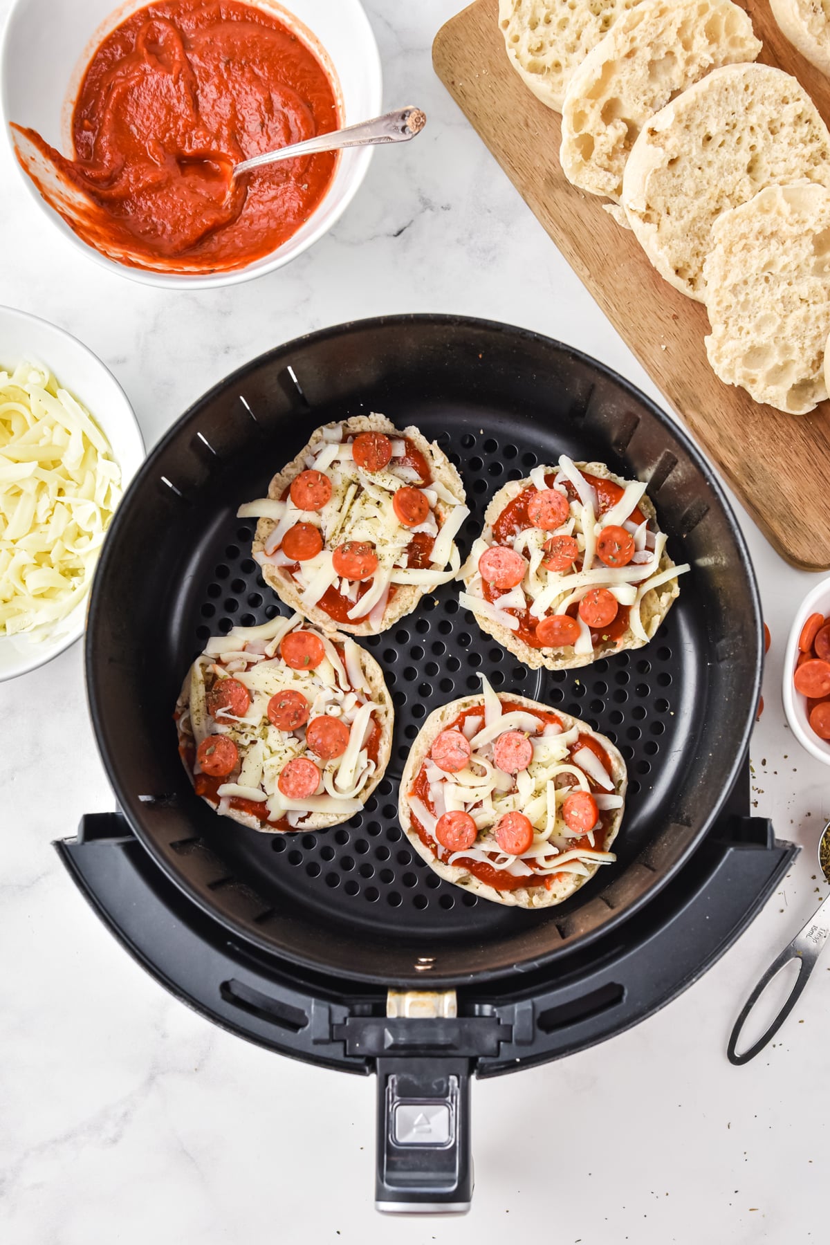 Servings of Air Fryer English Muffin Pizzas ready for cooking