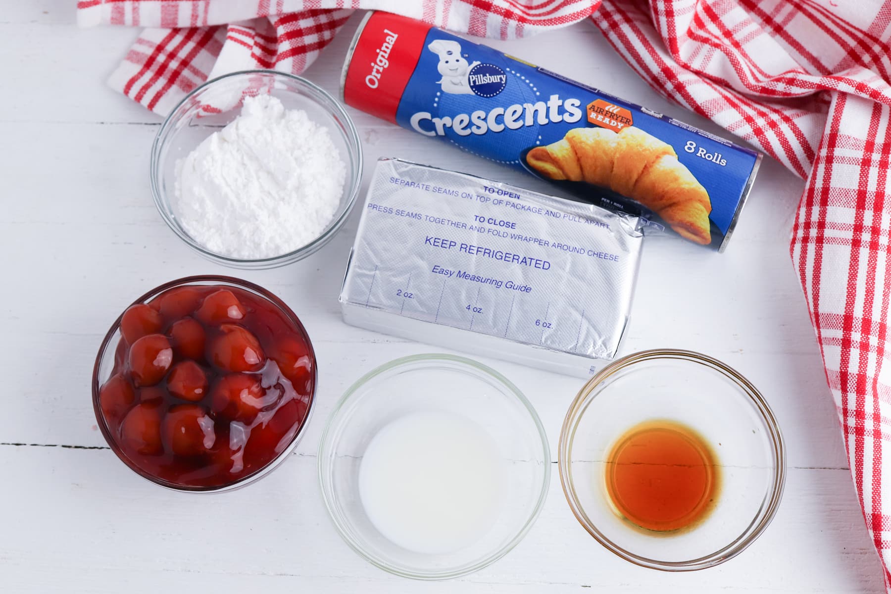 Ingredients for cherry cheesecake cups include crescent rolls , cream cheese, softened, vanilla extract, powdered sugar, cherry pie filling, powdered sugar, and cherry pie filling