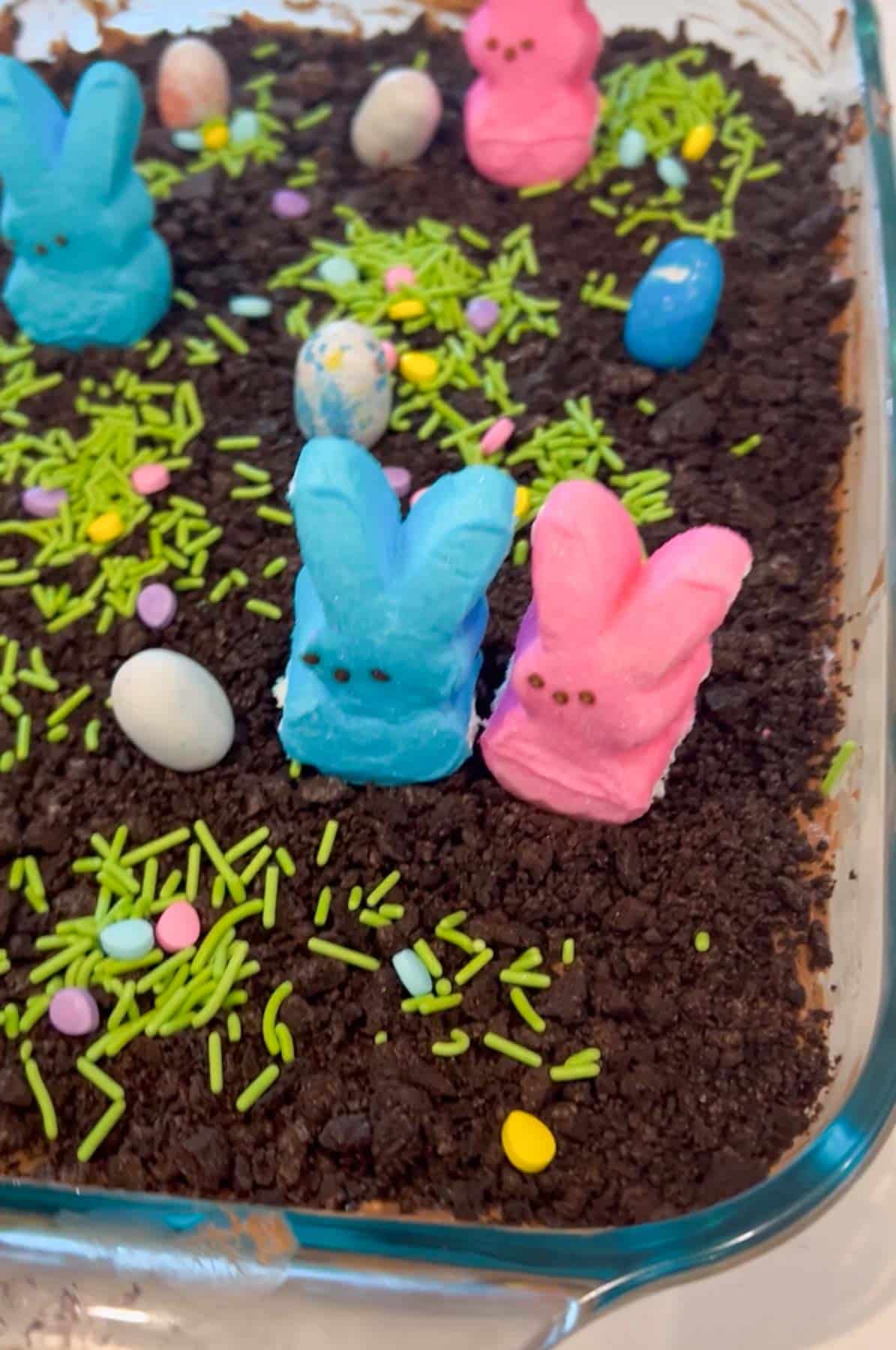 blue and pink bunny peeps on dirt cake