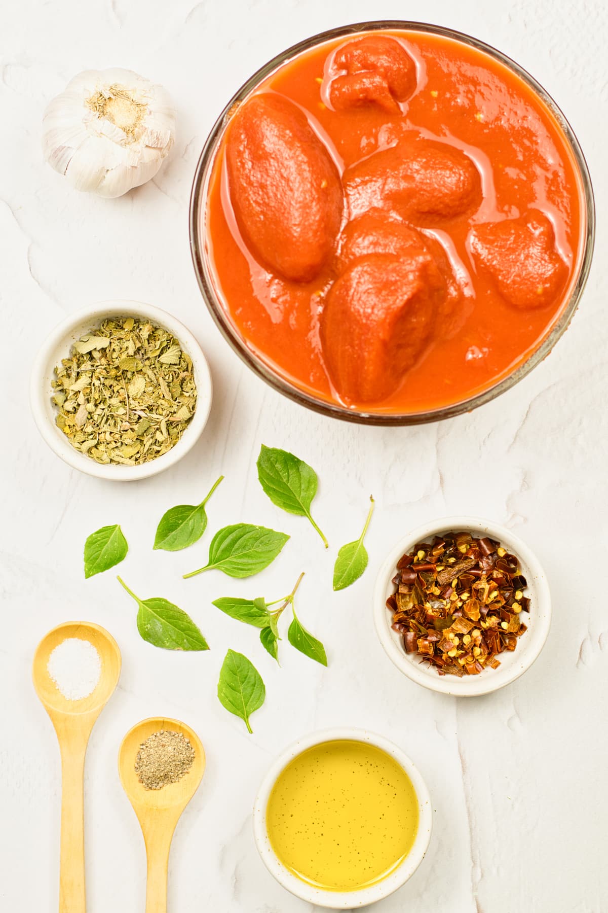 Ingredients for Italian Marinara Sauce Recipe are the following: garlic, tomatoes, olive oil, oregano, basil leaves, salt. red pepper flakes, black pepper