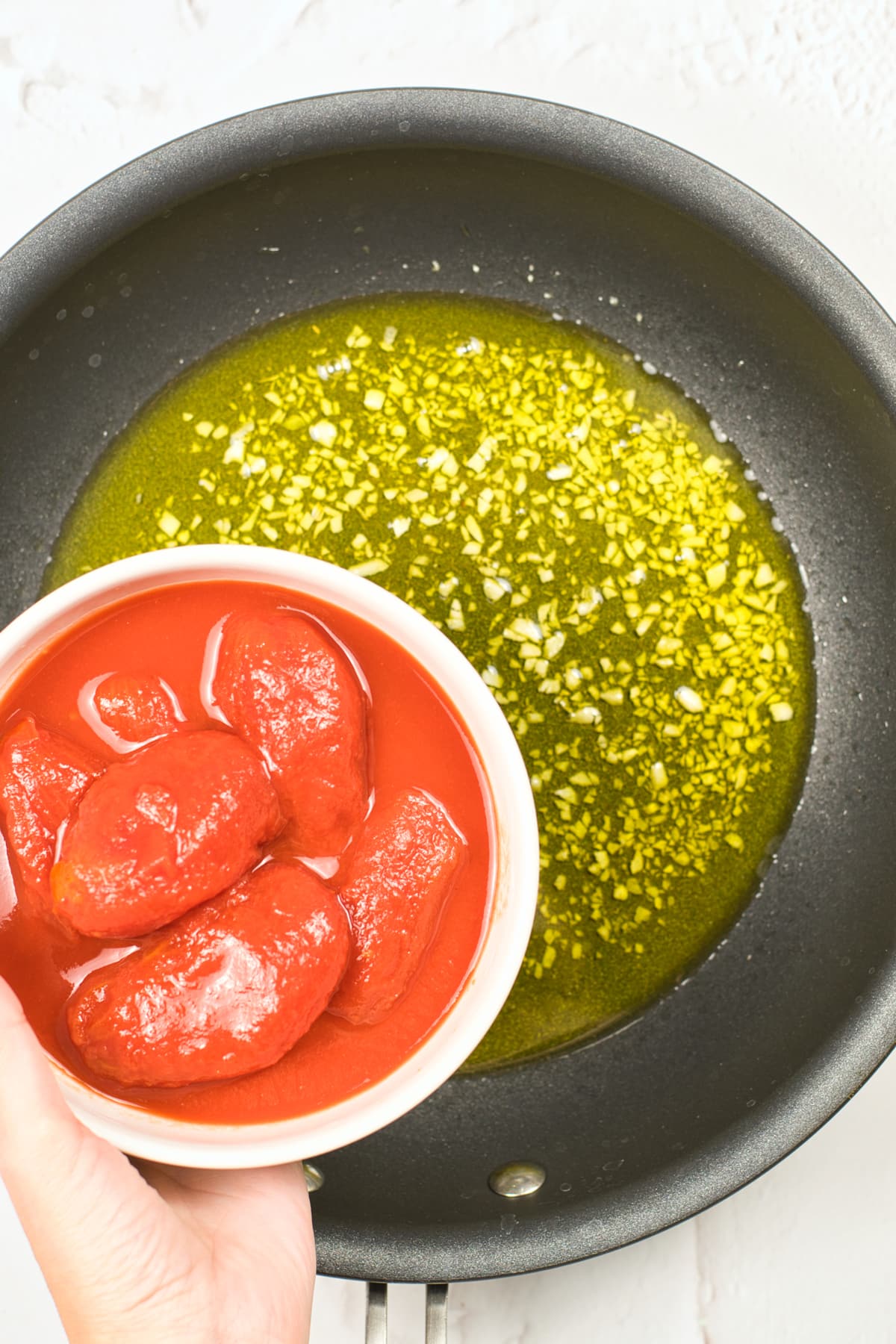 Process of preparing Italian Marinara Sauce Recipe is to add the tomato paste to the garlic