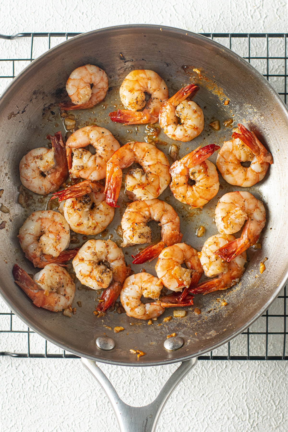 Another step in cooking Shrimp Scampi Recipe without Wine is to add the shrimps and wait for it to turn red.
