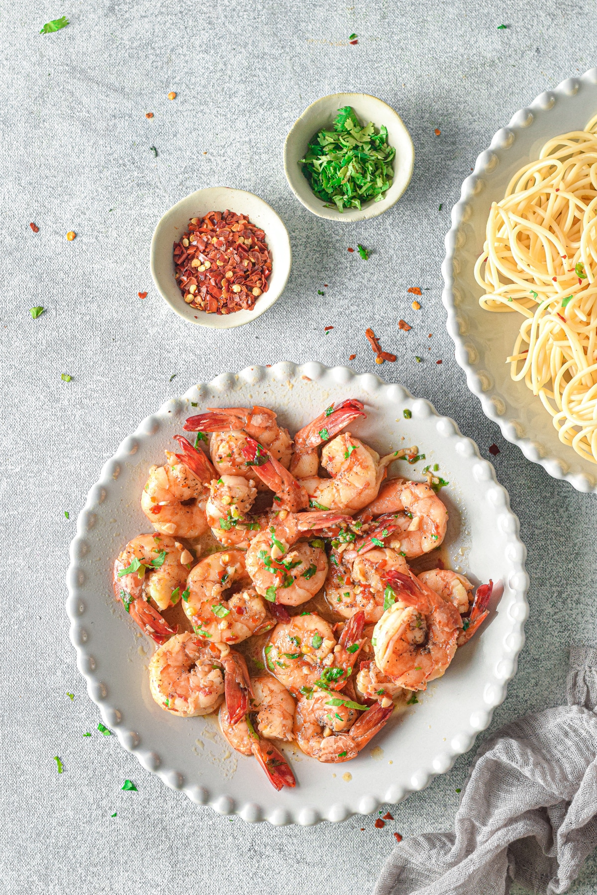 Shrimp Scampi Recipe without Wine on a white plate with linen on the side