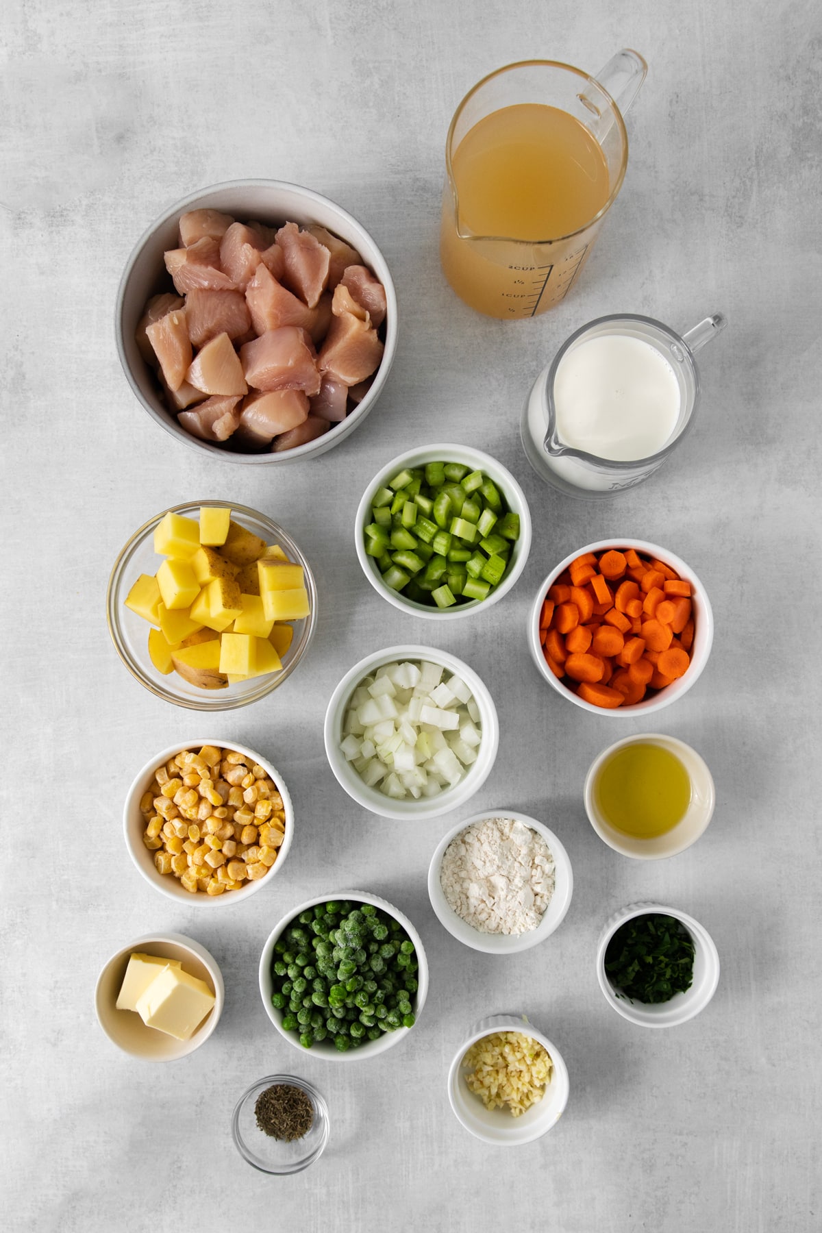 Ingredients for chicken pot pie soup includes olive oil, chicken breast, butter, carrots, celery, onion, garlic, thyme, all purpose flour, potatoes, peas, corn and parsley.