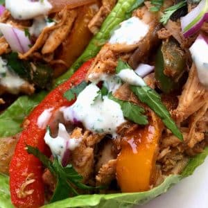 fajita with red and yellow peppers in lettuce wrap