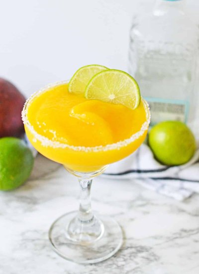 orange slushy drink with lime wedge