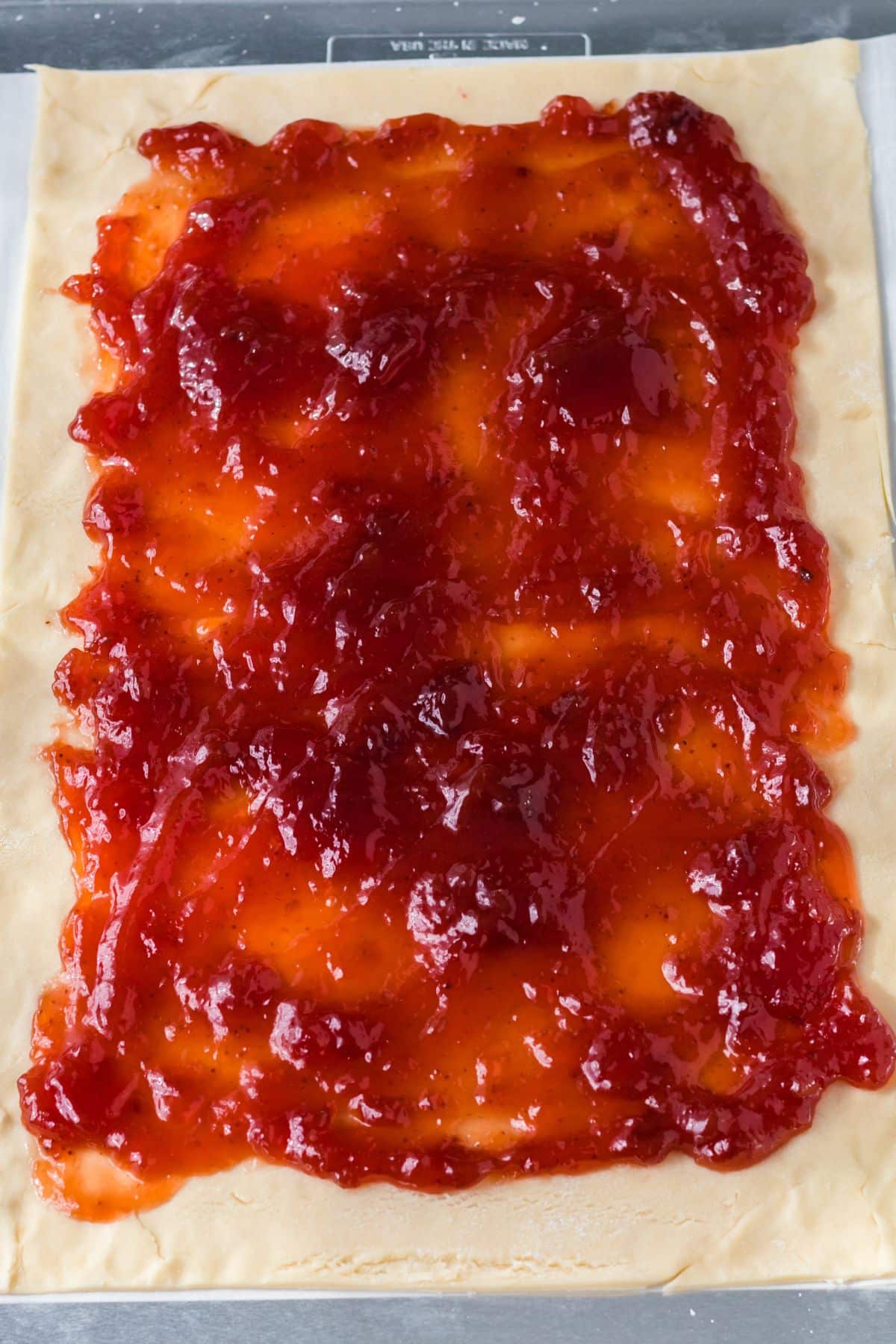 red jam on rectangle pie crust