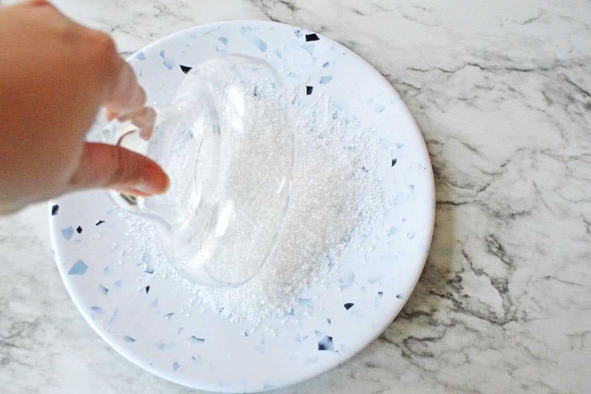 glass dipped into plate with salt