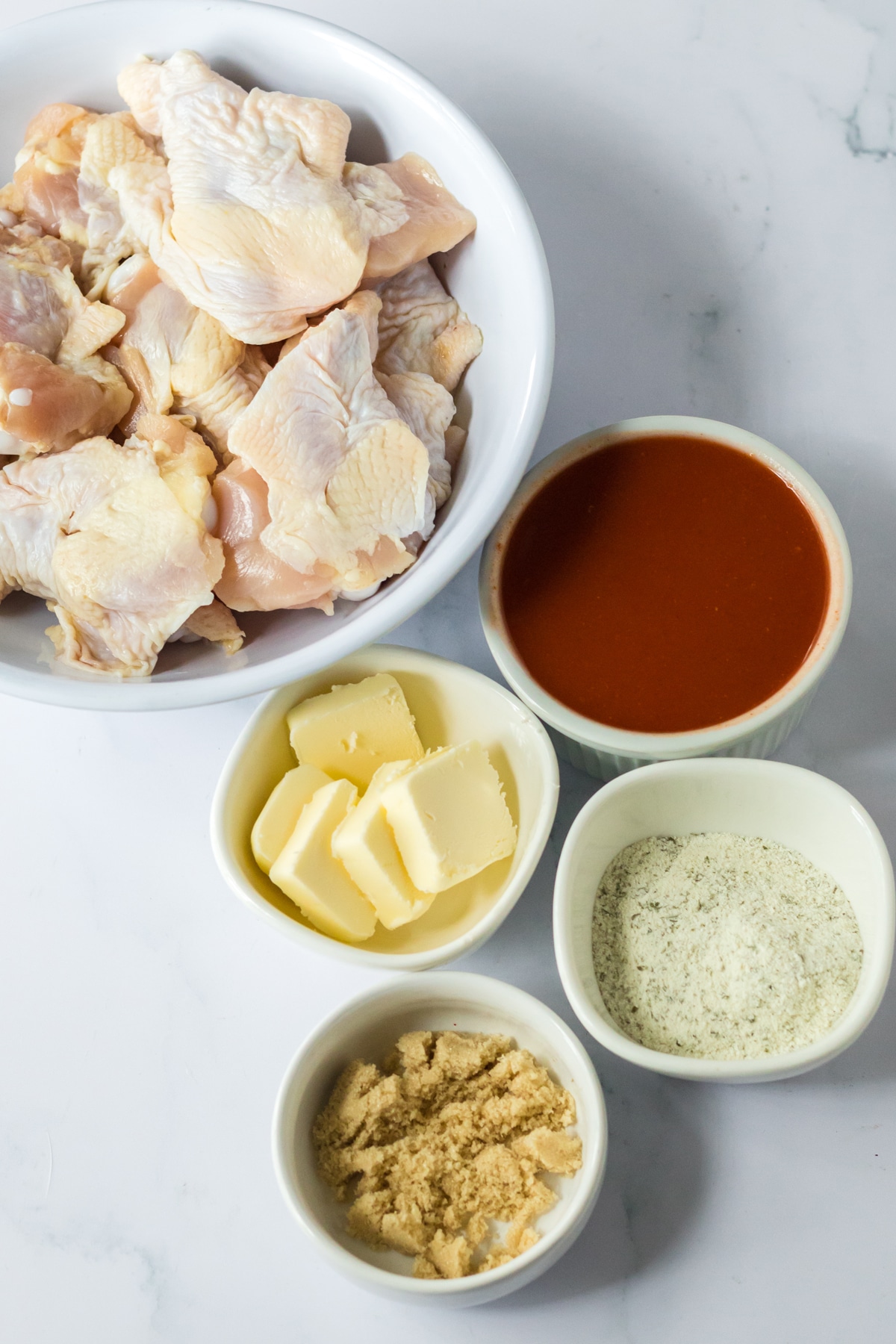 Ingredients for Slow Cooker Buffalo Ranch Wings include Fresh chicken wings, hot wing sauce (Frank's Buffalo Sauce or your favorite), dry ranch seasoning, brown sugar and butter