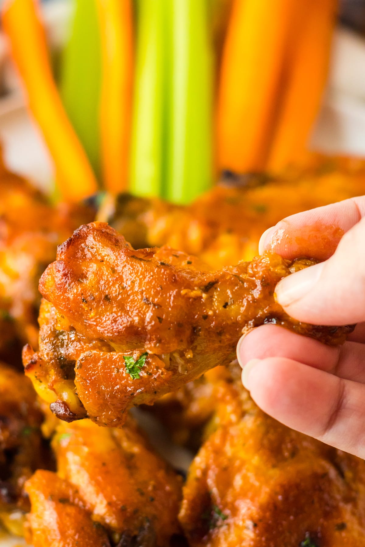 Holding a piece of Slow Cooker Buffalo Ranch Wings