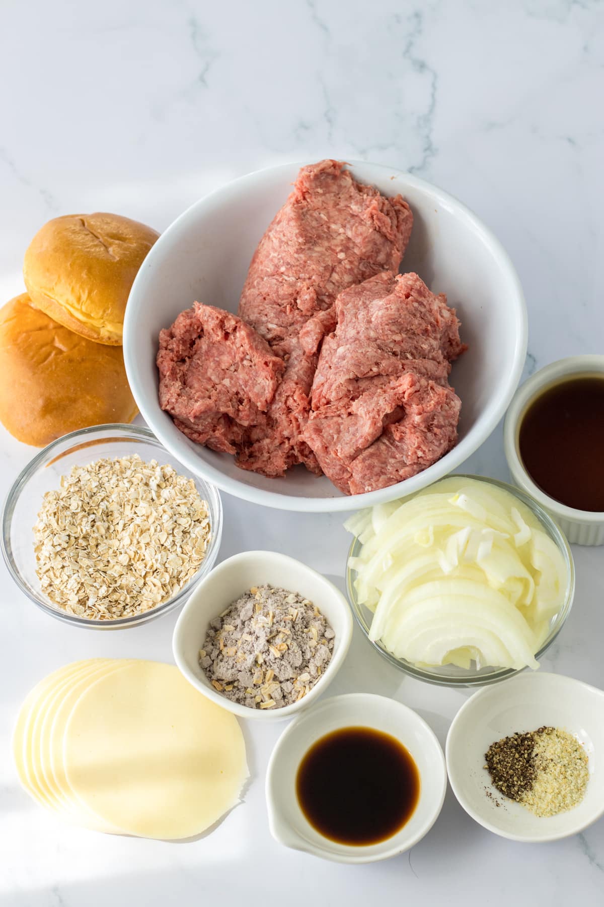 Ingredients for Slow Cooker French Dip Sloppy Joes includes lean ground beef, onion, quick cooking oatmeal (unflavored), beef broth, beefy onion soup mix, Worcestershire sauce (or soy sauce), garlic powder, black pepper, provolone cheese, and slider buns