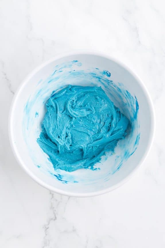 blue cookie dough in white bowl
