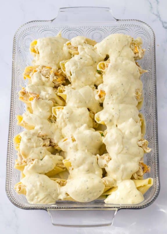 white sauce on top of crack chicken stuffed shells