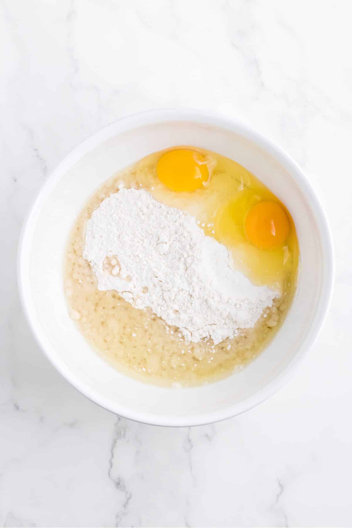 dry ingredients and eggs in white bowl