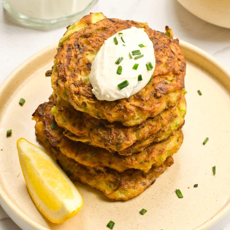 Zucchini Fritters with a slice of lemon on the side.