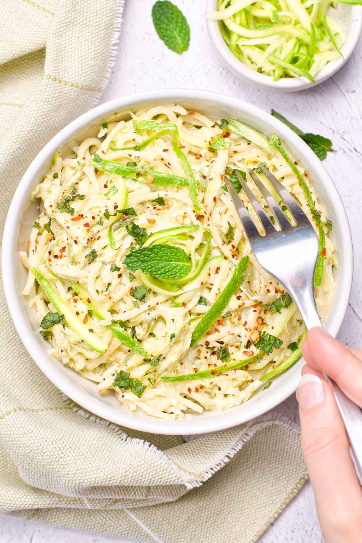 bowl with fork and zucchini pasta