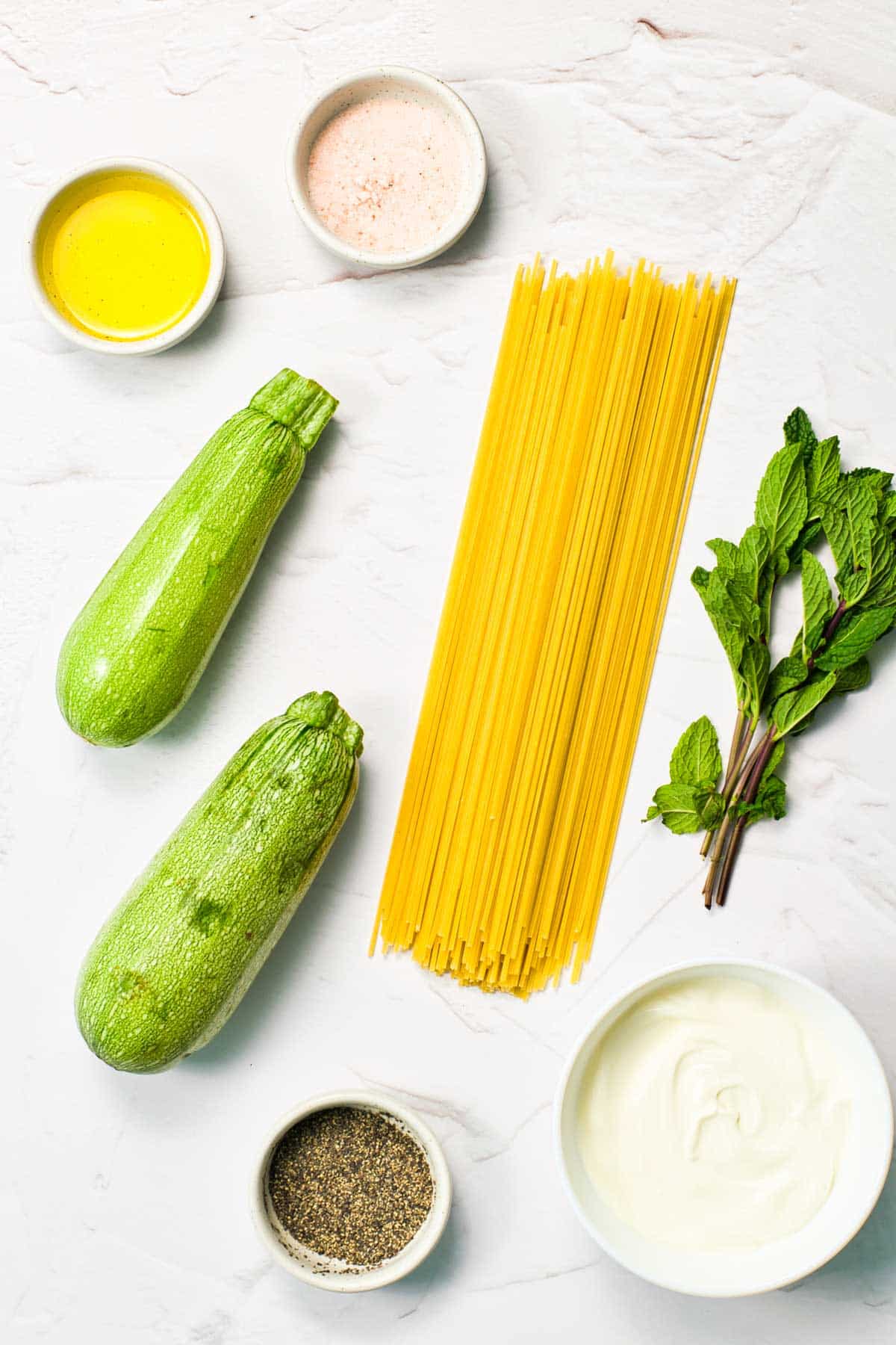 zucchini and pasta with seasonings on counter