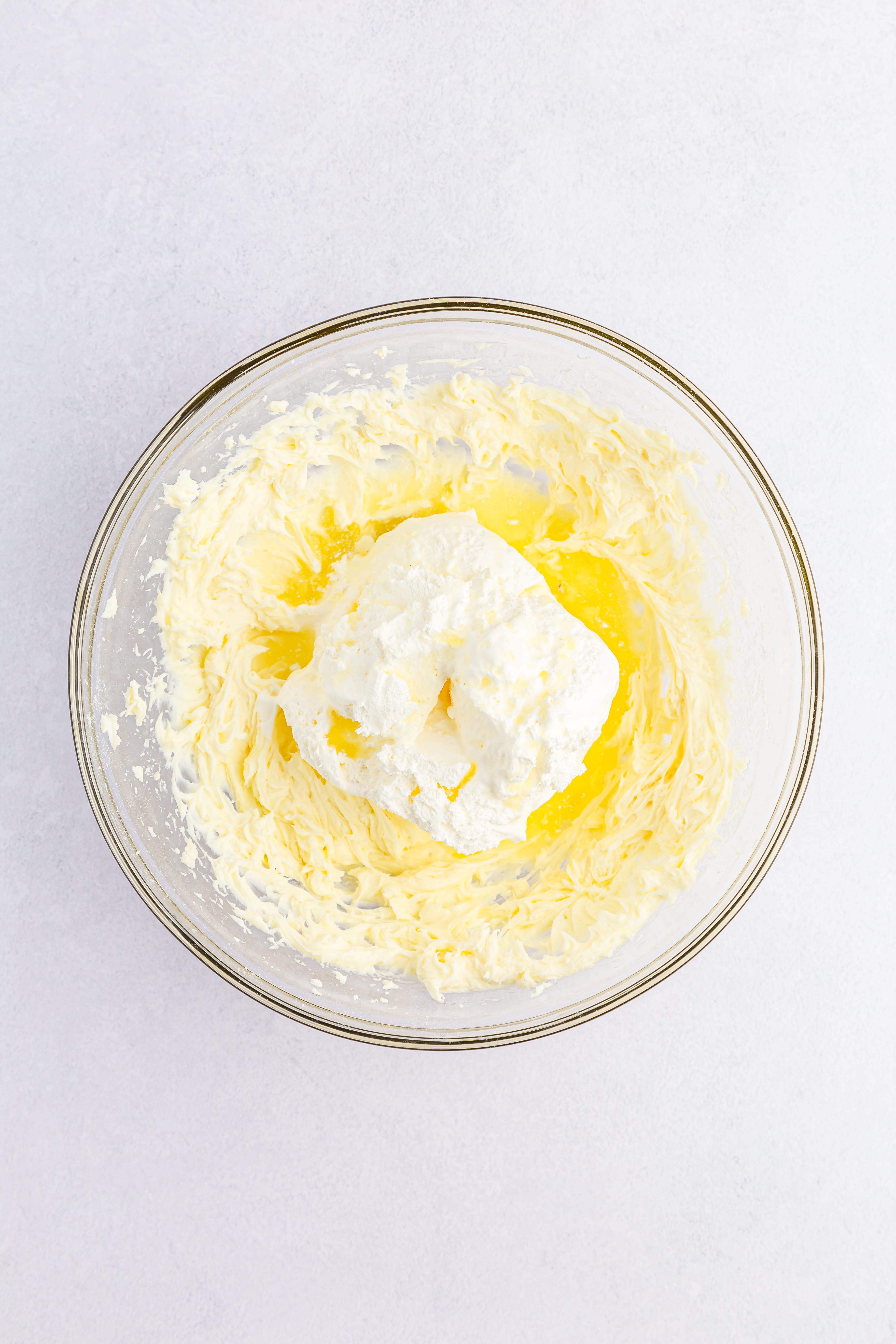 yellow cream in clear mixing bowl
