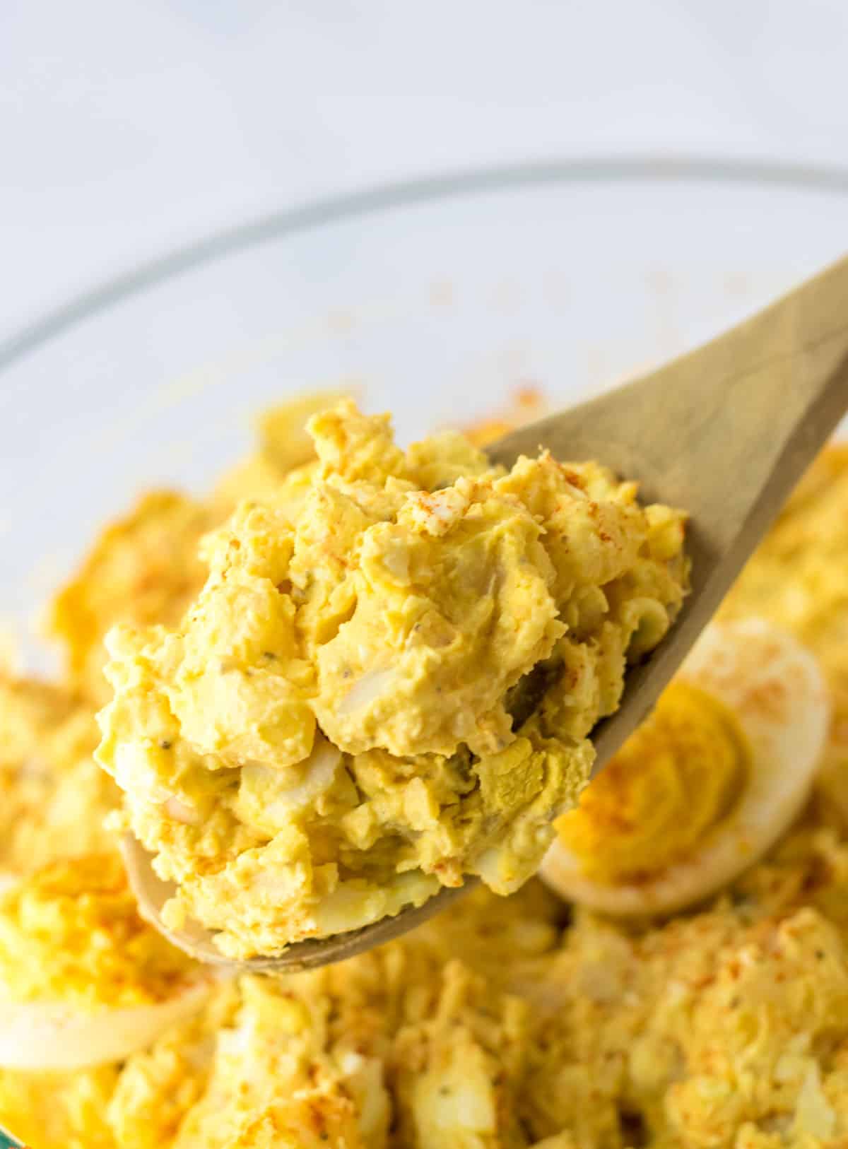 wooden spoon with deviled egg potato salad