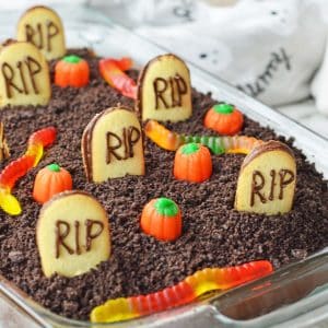 Halloween dessert in a glass dish featuring a spooky graveyard cake.