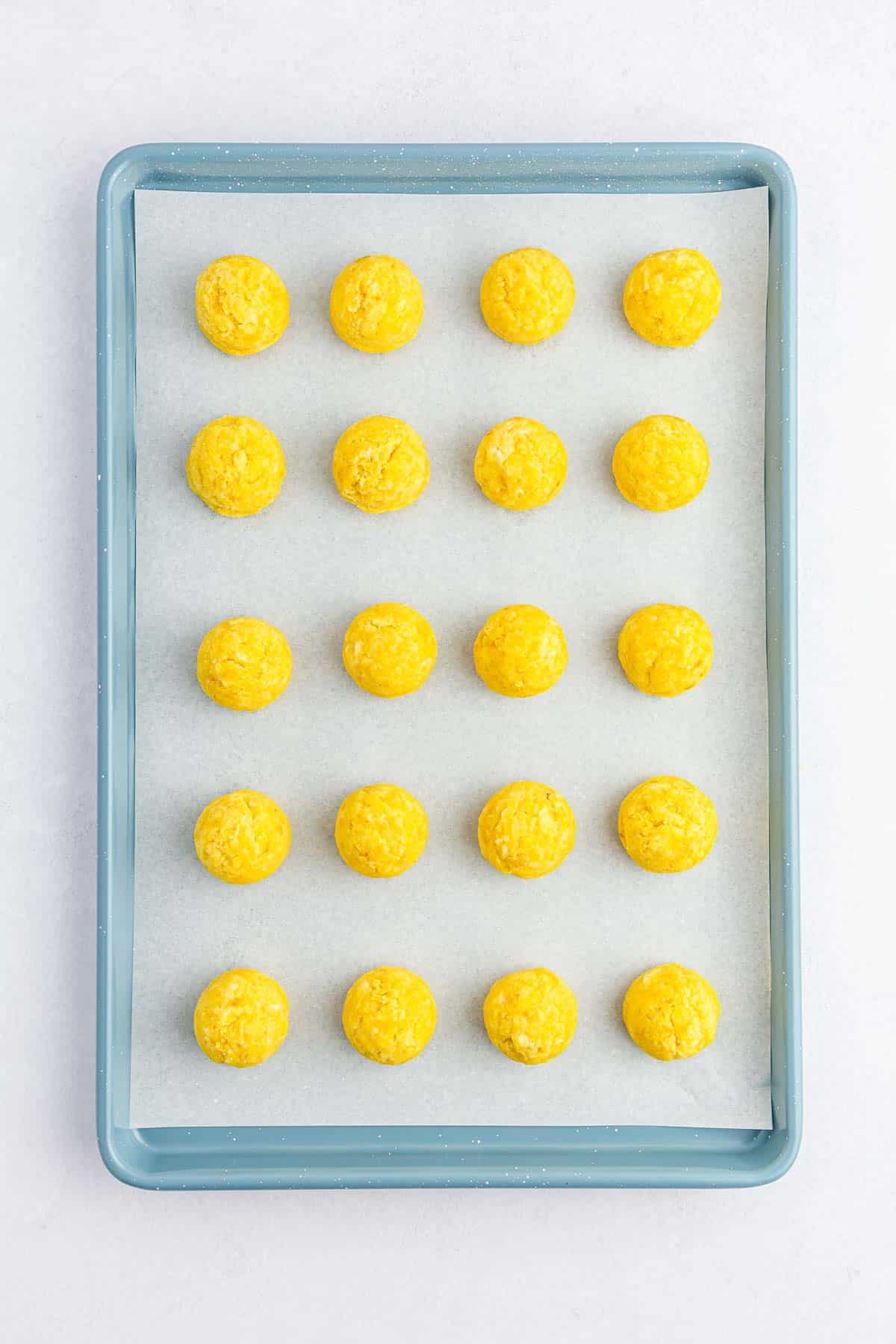 round yellow cake balls on baking sheet