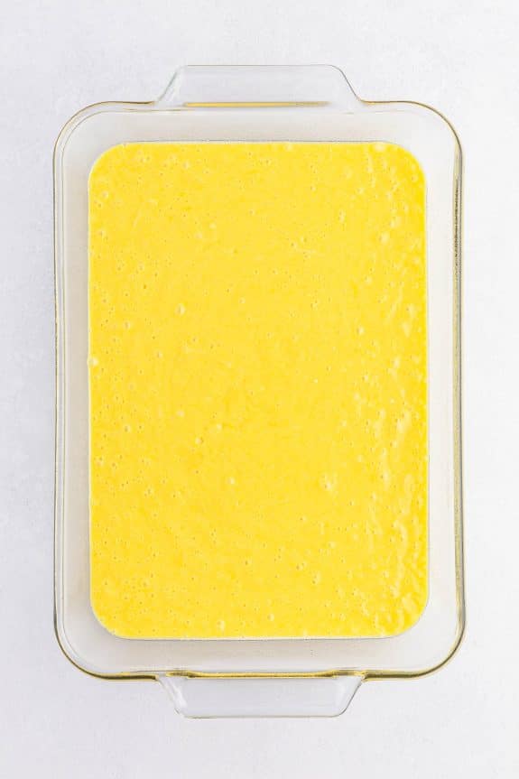 yellow cake mixture in glass baking dish