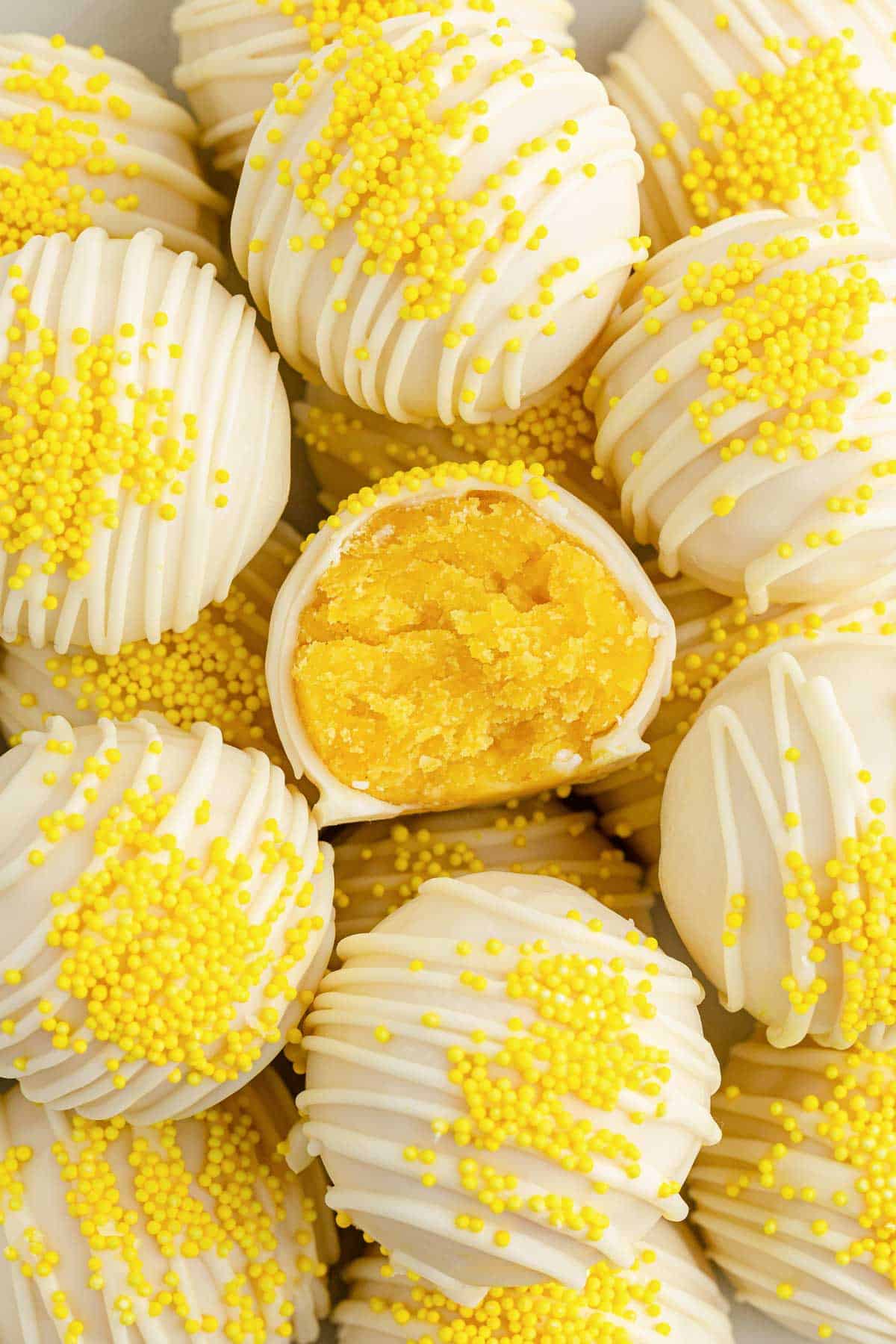 lemon cake balls close up with one cut in half