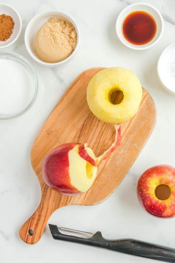 peeling apple on cutting board