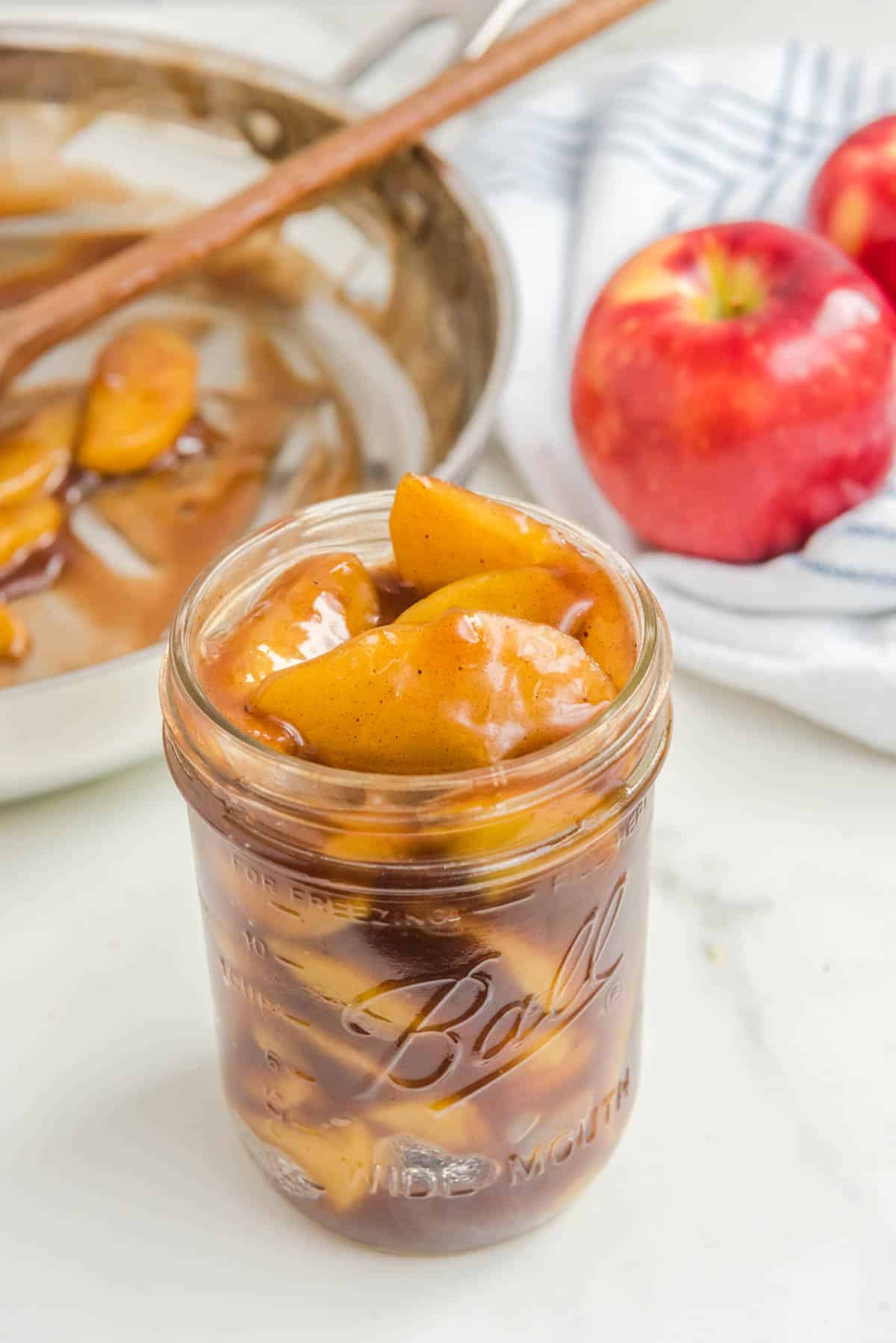 apple pie filling in mason jar with apples in background