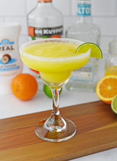creamsicle margarita with salted rim and lime slice