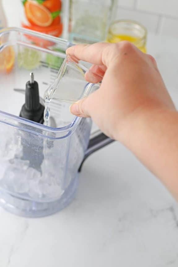 pouring lime juice into blender