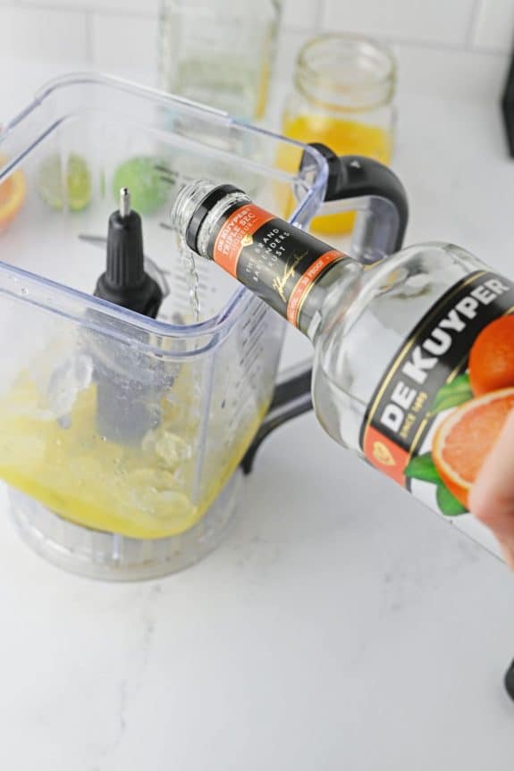 triple sec being poured into blender