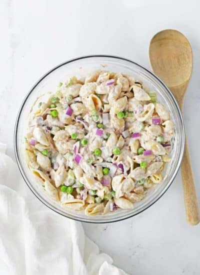 tuna salad in clear bowl with wooden spoon