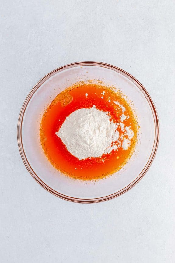 powder in orange jello in bowl