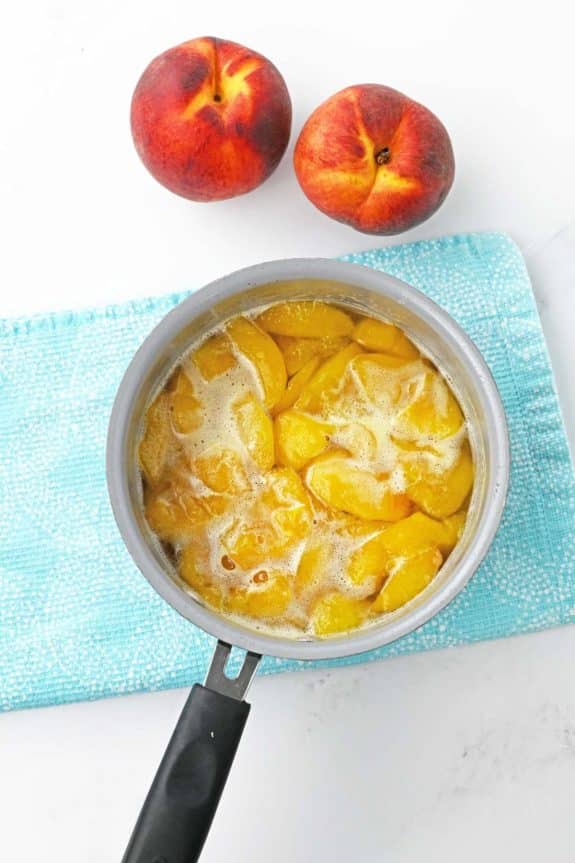 peaches and melted sugar in saucepan