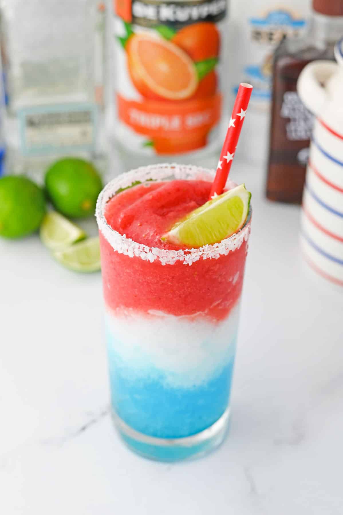 blue, white, then red slushie on top with lime wedge and red straw