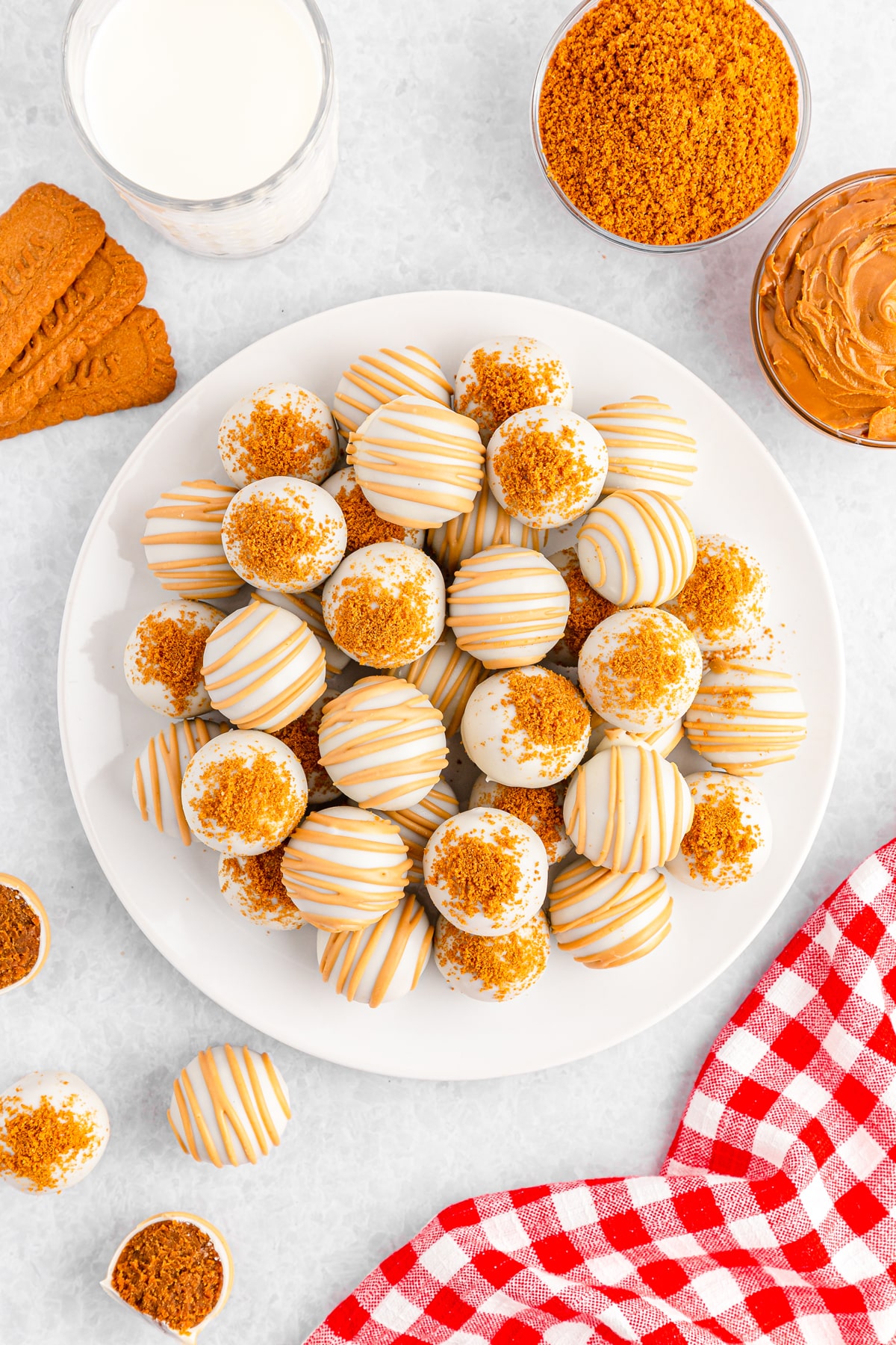 A serving of Biscoff Truffles with checkered linen, butter spread, and biscuits on the side.