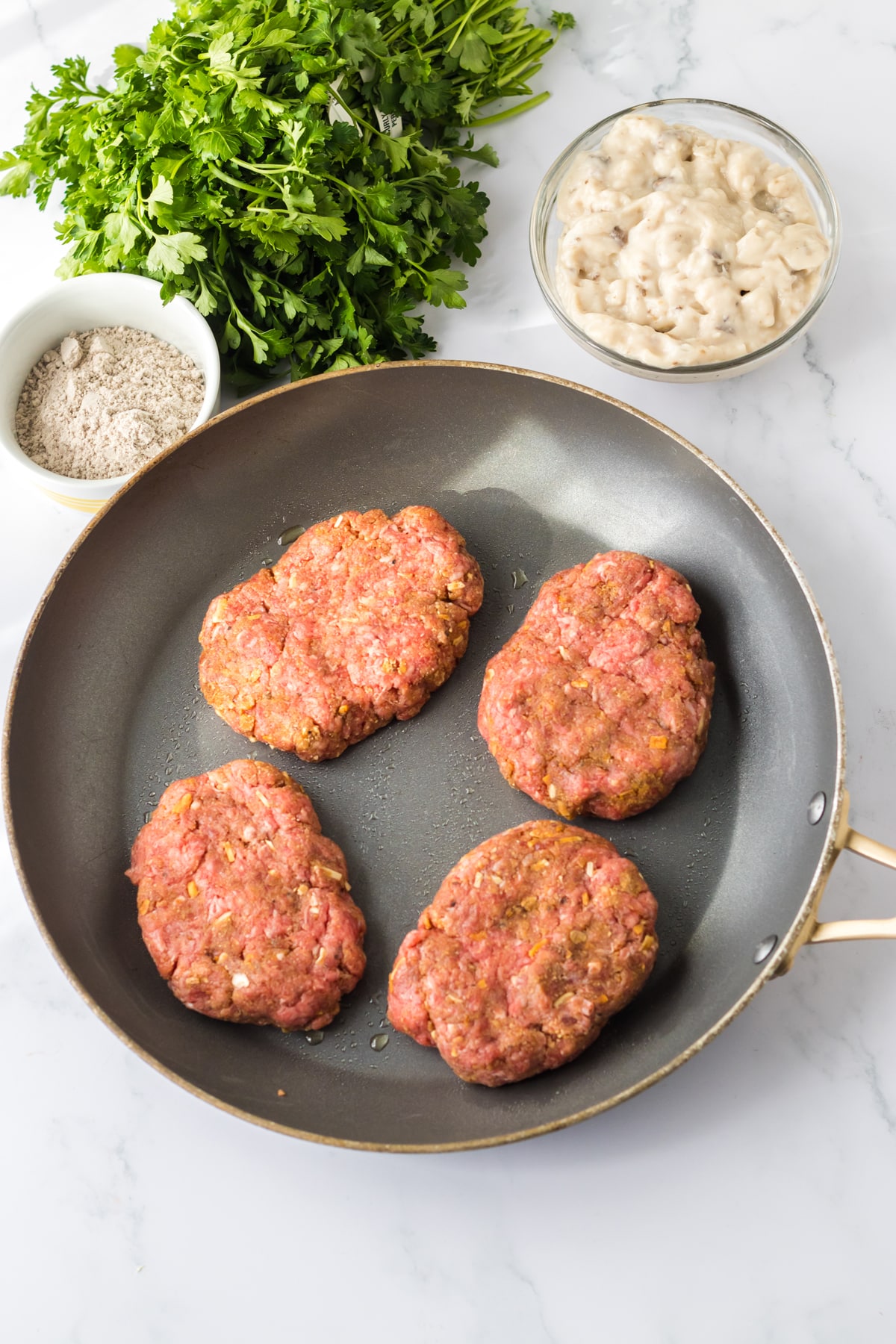 Next step in Slow Cooker Smothered Hamburgers is to shape the patties and put them over a pan.