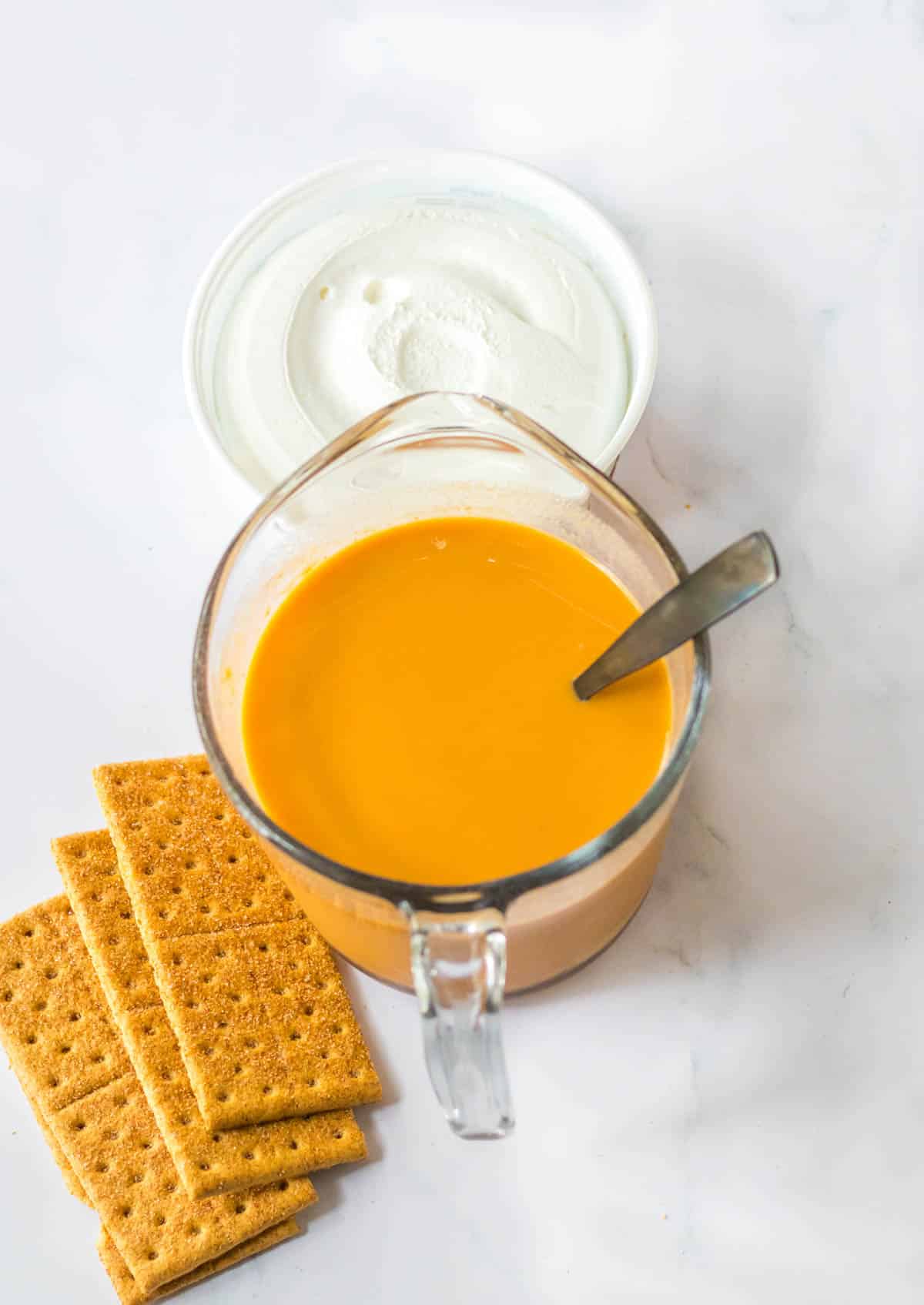 orange liquid in glass measuring cup
