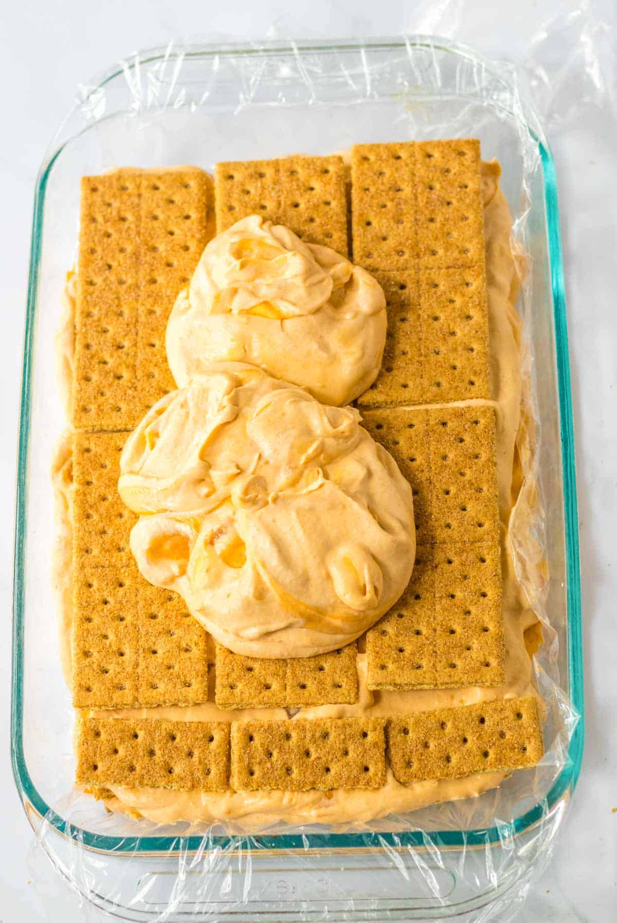 cheesecake layer on top of graham crackers in 9x13 pan